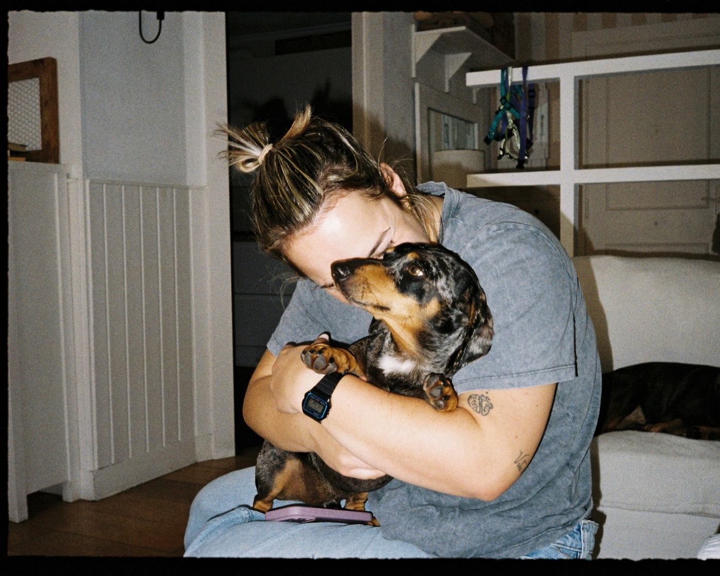 A person hugging their dog at home